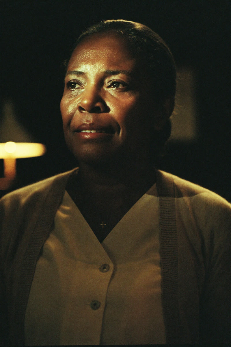 Concept portrait of Maria Thompson, a nurse with warm, resolute eyes