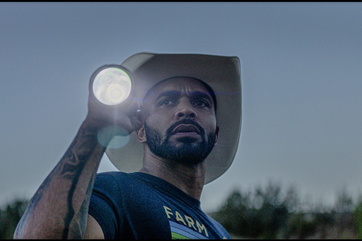 Dom in a cowboy hat and headlamp at the sanctuary after dark